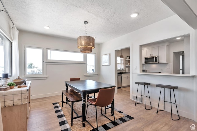 292 S 100 W, Provo, UT 84601 - dining room featuring a textured ceiling, light wood-style flooring, recessed lighting, and baseboards