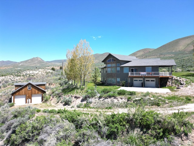 1940 E Shore Rd, Saint Charles, ID 83272 - view of front of home with a garage and a deck with mountain view