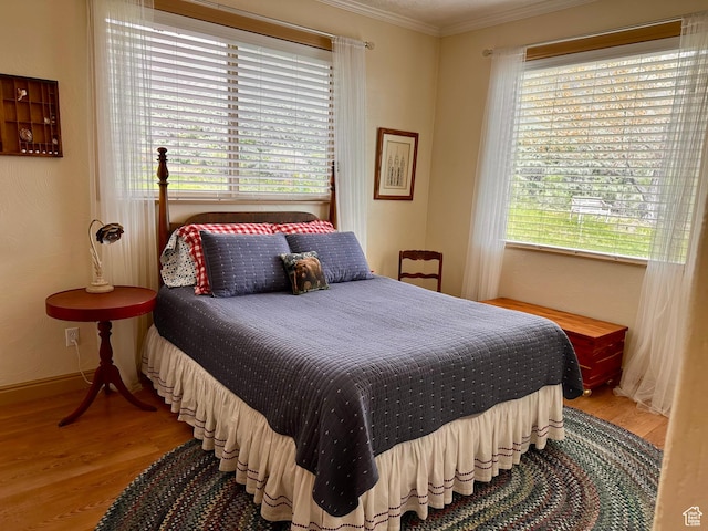 1940 E Shore Rd, Saint Charles, ID 83272 - bedroom featuring crown molding, wood finished floors, and multiple windows