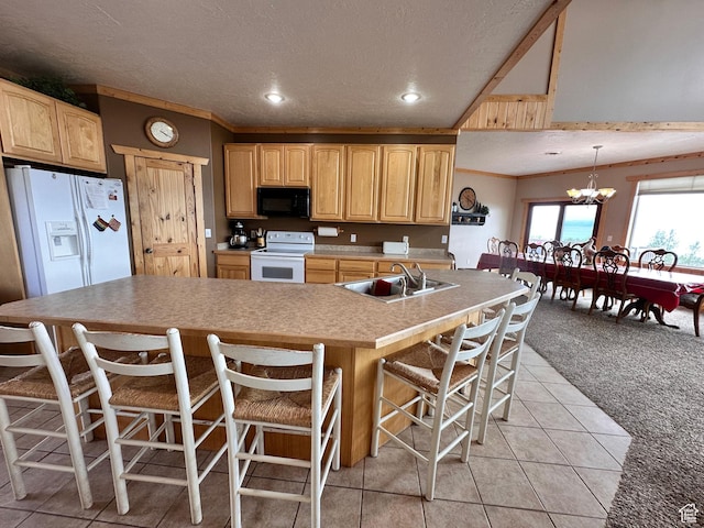1940 E Shore Rd, Saint Charles, ID 83272 - kitchen featuring white appliances, a sink, light brown cabinetry, a breakfast bar area, and a textured ceiling