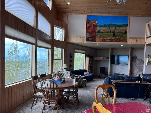 1940 E Shore Rd, Saint Charles, ID 83272 - carpeted dining space featuring wood walls, wood ceiling, and a towering ceiling