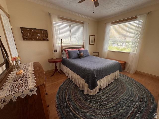 1940 E Shore Rd, Saint Charles, ID 83272 - bedroom with light wood-style flooring, ornamental molding, a textured ceiling, baseboards, and a ceiling fan
