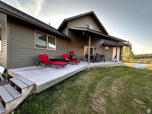 1940 E Shore Rd, Saint Charles, ID 83272 - back of property with a lawn and a deck