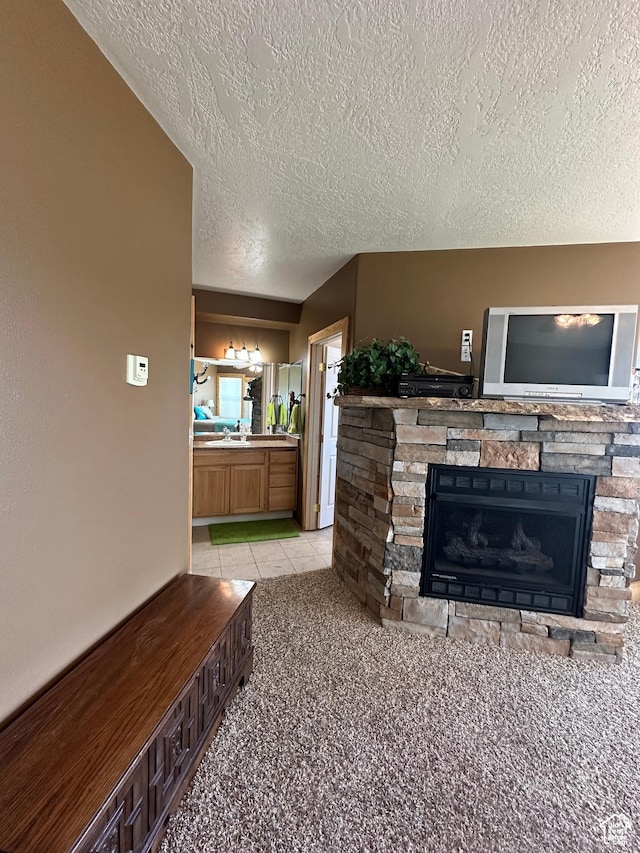 1940 E Shore Rd, Saint Charles, ID 83272 - living area with a fireplace, a textured ceiling, and light carpet