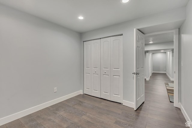 5058 W Blythswood Ln S, Herriman, UT 84096 - unfurnished bedroom featuring dark wood-style floors, baseboards, recessed lighting, and a closet
