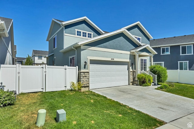 5058 W Blythswood Ln S, Herriman, UT 84096 - view of front of house featuring a gate, stucco siding, concrete driveway, an attached garage, and stone siding