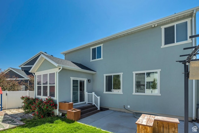 5058 W Blythswood Ln S, Herriman, UT 84096 - rear view of house featuring stucco siding and a patio