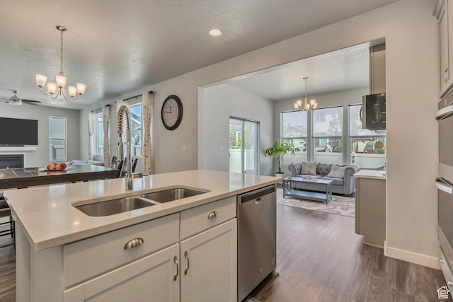 5058 W Blythswood Ln S, Herriman, UT 84096 - kitchen with open floor plan, a chandelier, stainless steel appliances, a sink, and recessed lighting