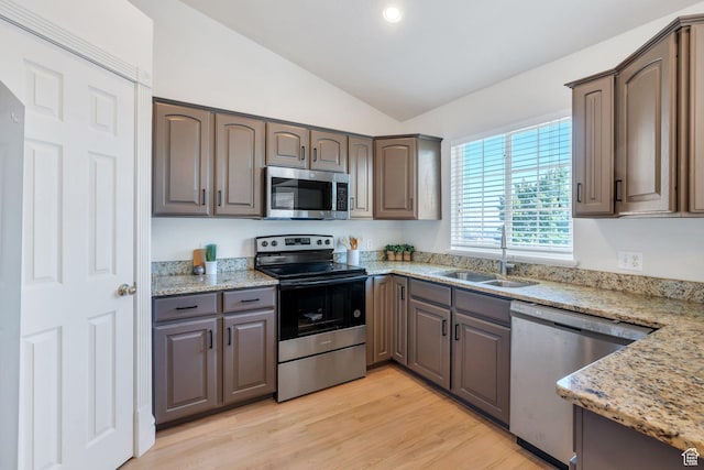 69 E Hudson Dr, Elk Ridge, UT 84651 - kitchen featuring stainless steel appliances, a sink, vaulted ceiling, light wood finished floors, and light stone counters