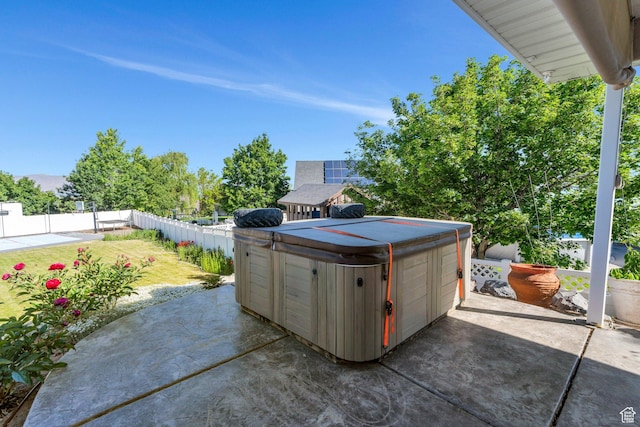 69 E Hudson Dr, Elk Ridge, UT 84651 - fenced backyard with a hot tub, a patio, and a detached garage