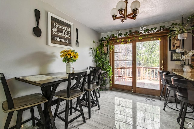 628 N Sir Philip Dr, Salt Lake City, UT 84116 - dining area featuring a chandelier and a textured ceiling