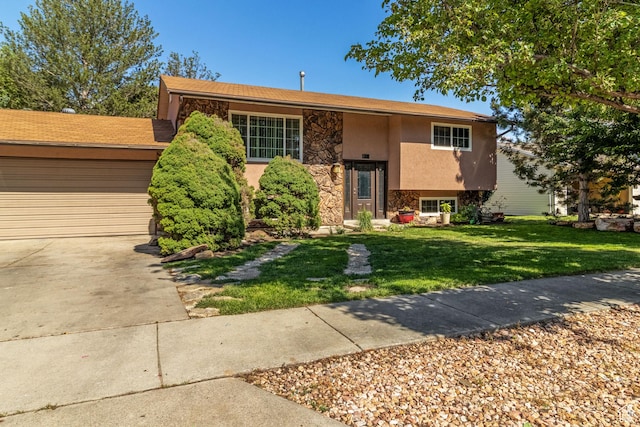 628 N Sir Philip Dr, Salt Lake City, UT 84116 - split foyer home featuring stone siding, a front lawn, driveway, stucco siding, and a garage