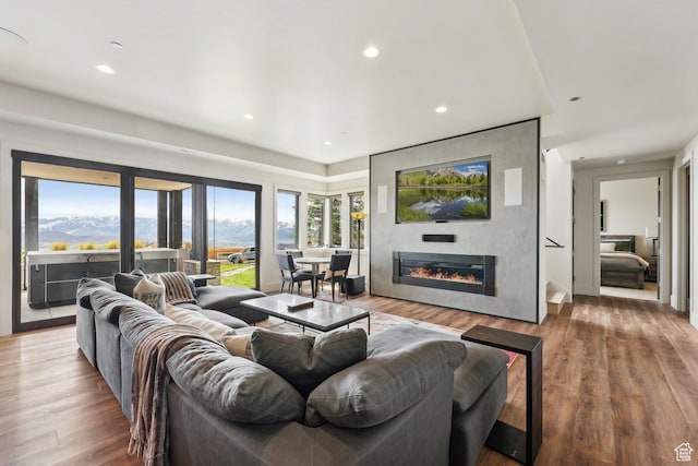 8982 N Mountain Crest Rd, Park City, UT 84098 - living room featuring wood finished floors, a glass covered fireplace, and recessed lighting