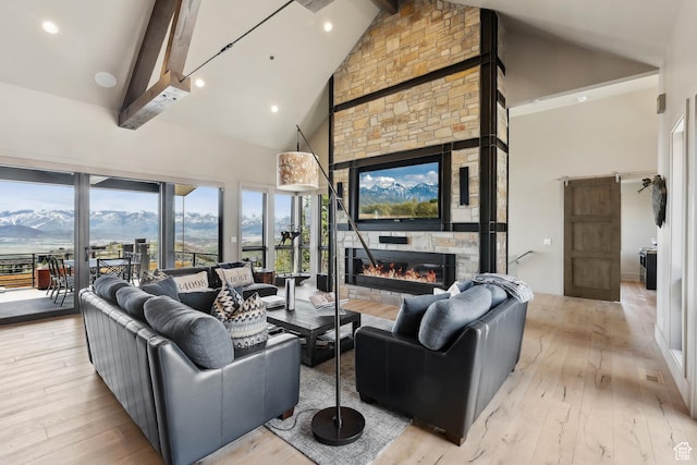 8982 N Mountain Crest Rd, Park City, UT 84098 - living room with a fireplace, high vaulted ceiling, beamed ceiling, and hardwood / wood-style flooring