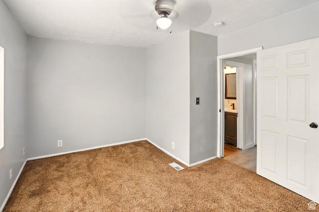 2411 S D Ave E, Ogden, UT 84401 - empty room featuring light carpet, baseboards, ceiling fan, and a smoke detector