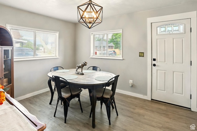 2411 S D Ave E, Ogden, UT 84401 - dining space featuring a chandelier, wood finished floors, and baseboards