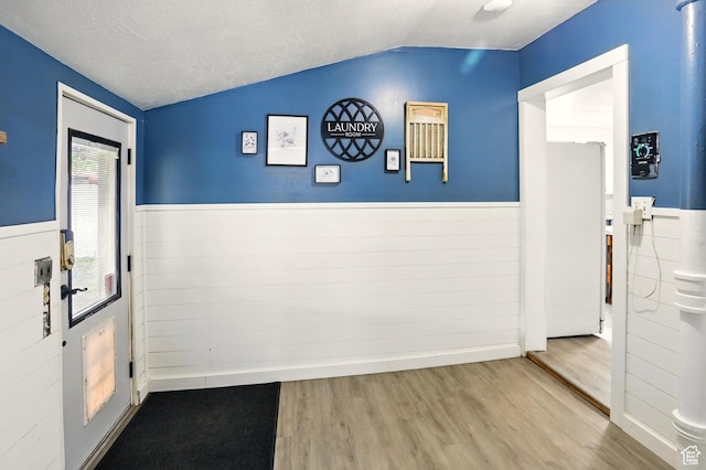 2411 S D Ave E, Ogden, UT 84401 - doorway with wood finished floors, lofted ceiling, and a wainscoted wall