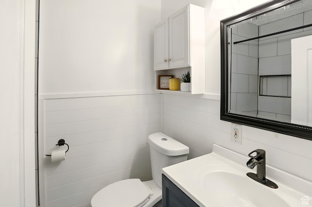 2411 S D Ave E, Ogden, UT 84401 - bathroom featuring toilet, vanity, and tile walls