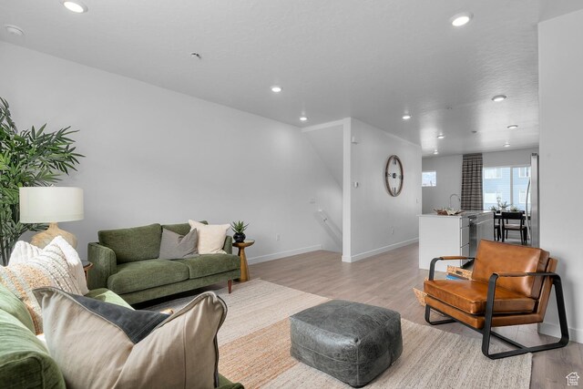 412 S 1110 W Unit 215, American Fork, UT 84003 - living area featuring light wood finished floors, recessed lighting, and baseboards