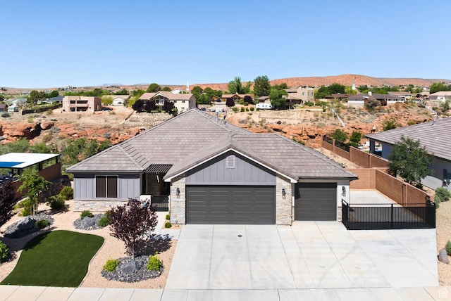 833 N Camino Pico, Washington, UT 84780 - ranch-style home featuring an attached garage, board and batten siding, stone siding, and driveway