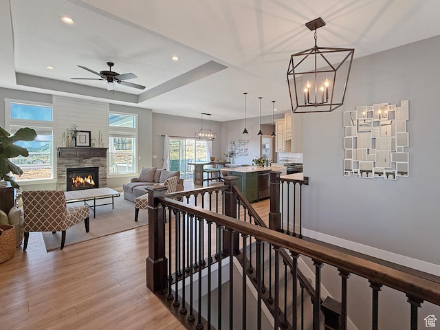 3723 N 500 E, North Ogden, UT 84414 - hall with light wood-type flooring, an upstairs landing, a chandelier, a raised ceiling, and recessed lighting