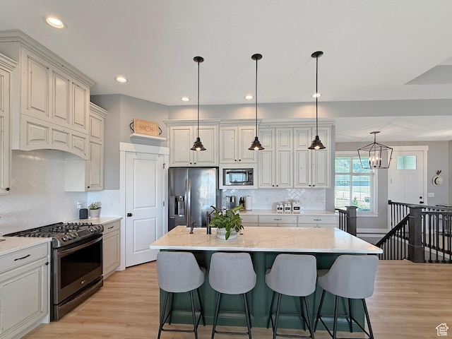 3723 N 500 E, North Ogden, UT 84414 - kitchen with stainless steel appliances, light wood-style floors, backsplash, light stone countertops, and recessed lighting