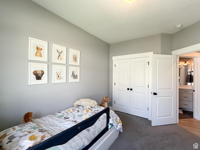 3723 N 500 E, North Ogden, UT 84414 - bedroom featuring a closet, a textured ceiling, and dark colored carpet