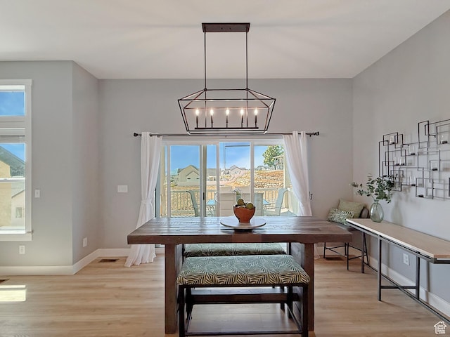 3723 N 500 E, North Ogden, UT 84414 - dining space featuring light wood-style floors, baseboards, and a chandelier