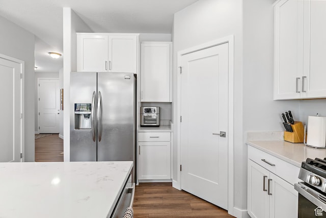 15022 S Halter Way W, Bluffdale, UT 84065 - kitchen with appliances with stainless steel finishes, dark wood-type flooring, and white cabinetry