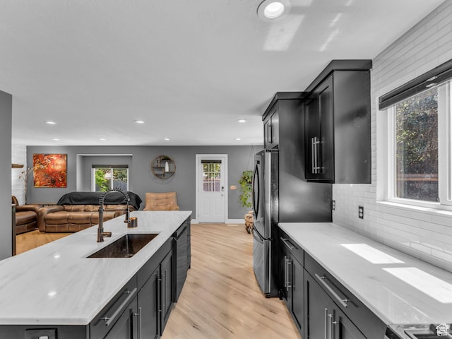 10685 S Superior Cir E, Sandy, UT 84094 - kitchen featuring a sink, light wood-style floors, recessed lighting, black dishwasher, and tasteful backsplash