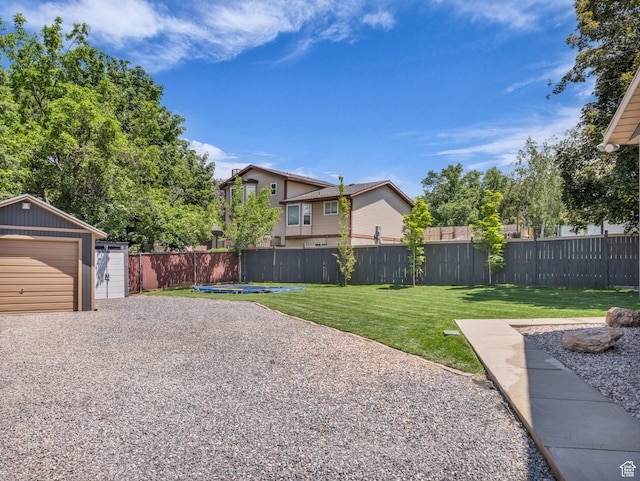10685 S Superior Cir E, Sandy, UT 84094 - view of yard with an outbuilding, driveway, and a detached garage