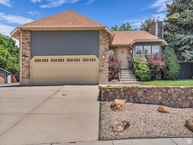 10685 S Superior Cir E, Sandy, UT 84094 - view of front of home with a shingled roof, a chimney, driveway, brick siding, and an attached garage