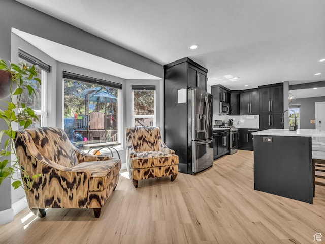 10685 S Superior Cir E, Sandy, UT 84094 - kitchen with dark cabinets, appliances with stainless steel finishes, light countertops, plenty of natural light, and recessed lighting