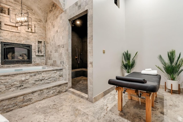 2836 S 2300th Cir E, St George, UT 84790 - bathroom featuring marble finish floors, a chandelier, tiled shower, a fireplace, and a garden tub