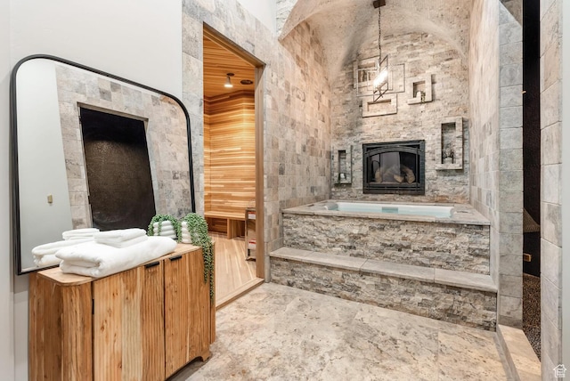 2836 S 2300th Cir E, St George, UT 84790 - bathroom with a stone fireplace, a bath, and vaulted ceiling