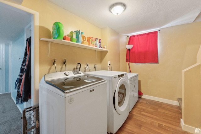 717 9th St, Ogden, UT 84404 - laundry room with separate washer and dryer, light wood-style flooring, baseboards, and a textured ceiling