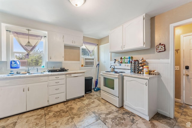 717 9th St, Ogden, UT 84404 - kitchen featuring white appliances, a sink, a wainscoted wall, white cabinetry, and light countertops