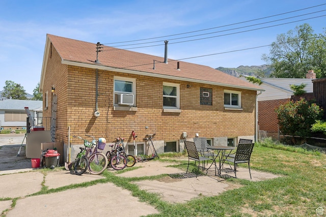 717 9th St, Ogden, UT 84404 - rear view of house featuring a patio, brick siding, a shingled roof, and cooling unit