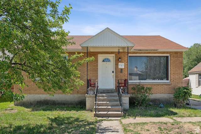 717 9th St, Ogden, UT 84404 - view of front of house with brick siding and a shingled roof