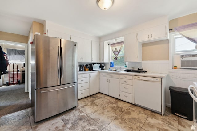 717 9th St, Ogden, UT 84404 - kitchen with freestanding refrigerator, white dishwasher, light countertops, white cabinetry, and wainscoting