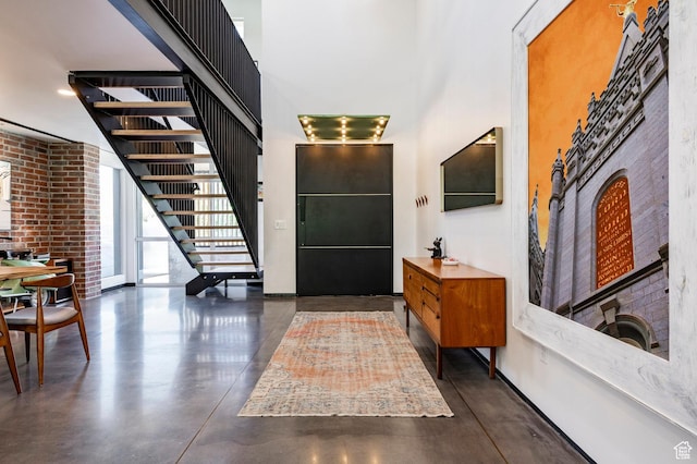 1983 W Ranch Rd, Farmington, UT 84025 - entryway with a towering ceiling, concrete flooring, stairs, and baseboards
