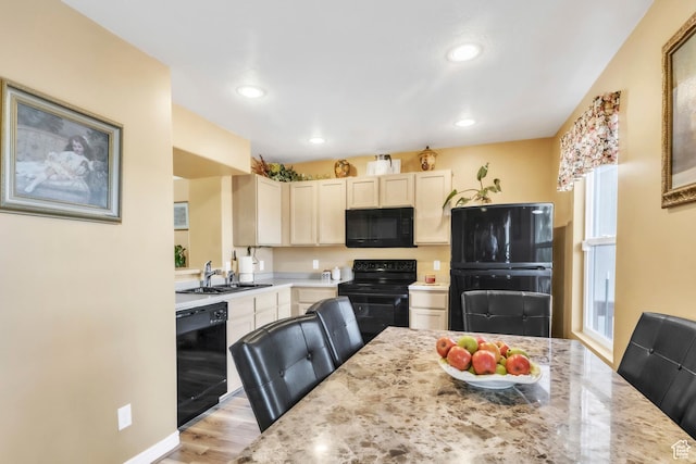 463 E Braidhill Dr, Draper, UT 84020 - kitchen with black appliances, a sink, recessed lighting, light wood-style floors, and light stone countertops