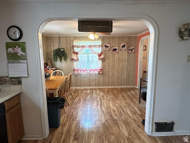 50 N 100 E, Meadow, UT 84644 - dining room featuring arched walkways, light wood-style floors, baseboards, wood walls, and ceiling fan