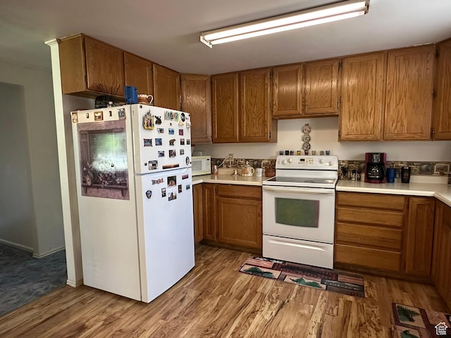 50 N 100 E, Meadow, UT 84644 - kitchen with white appliances, wood finished floors, brown cabinets, and light countertops