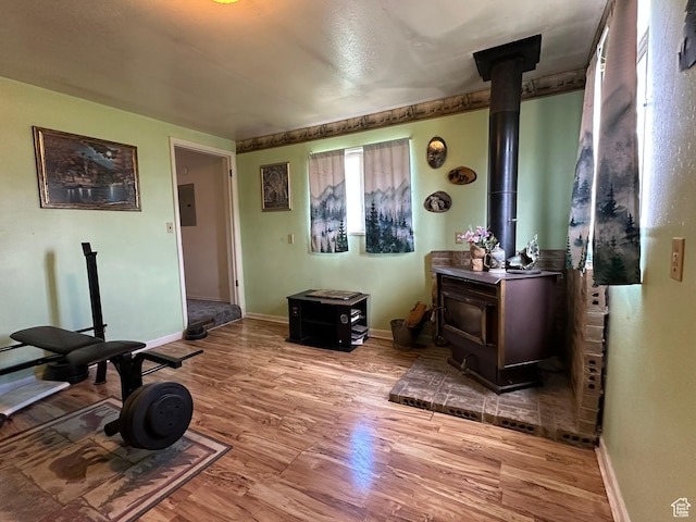 50 N 100 E, Meadow, UT 84644 - workout room featuring a wood stove, wood finished floors, and baseboards