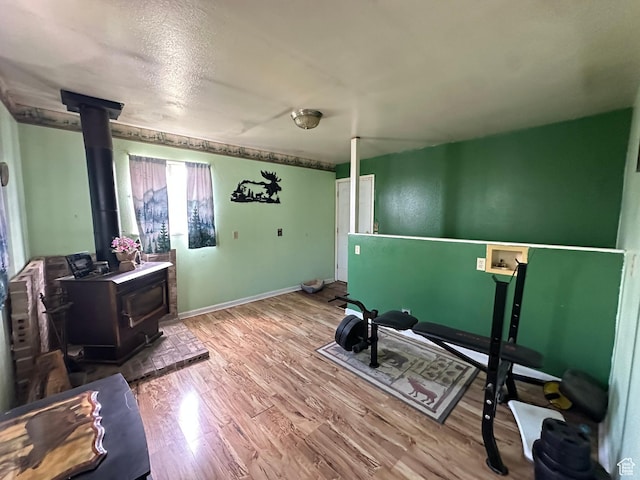 50 N 100 E, Meadow, UT 84644 - exercise area with a wood stove, wood finished floors, and baseboards