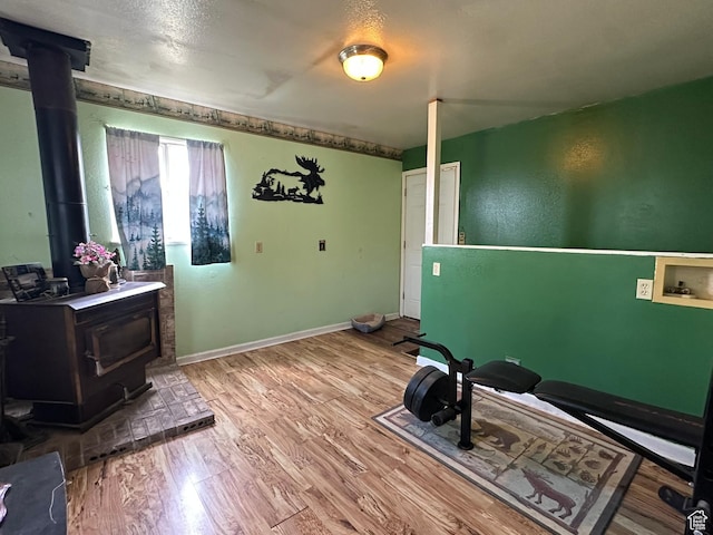 50 N 100 E, Meadow, UT 84644 - workout area with a wood stove, wood finished floors, and baseboards