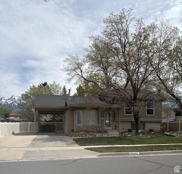 9835 S 610 E, Sandy, UT 84070 - view of front of house with driveway, a carport, and brick siding