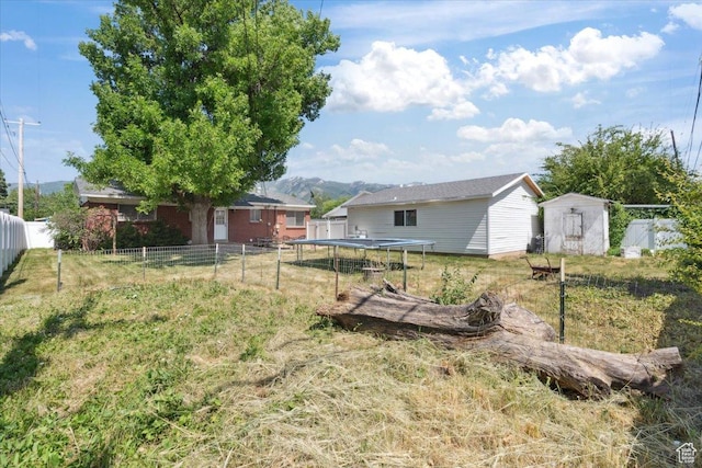 175 Green Dr, Layton, UT 84041 - view of yard with a trampoline and a mountain view