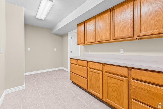 11815 S Cottage Side Way E, Draper, UT 84020 - kitchen featuring light countertops, light tile patterned floors, and baseboards